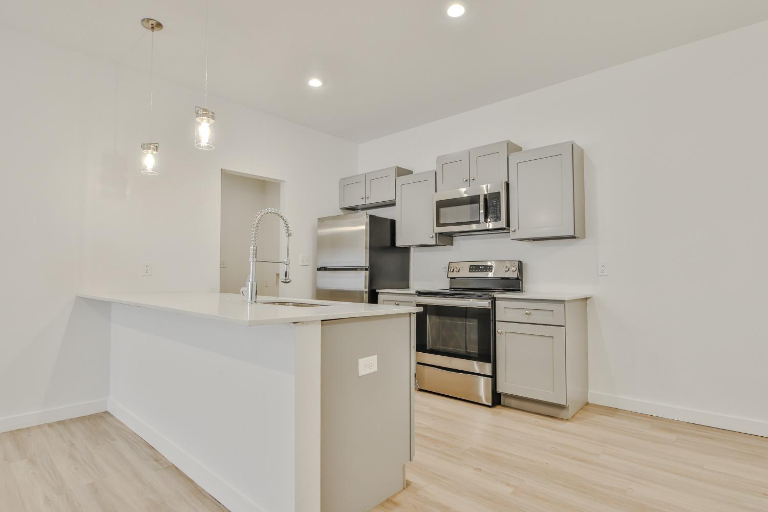5508 Itasca Street Lubbock, TX 79416 - Photo 6 of 25 a kitchen with stainless steel appliances granite countertop a stove top oven a sink and white cabinets