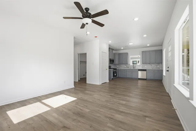 a view of a kitchen with a sink and a refrigerator