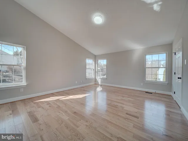 a large kitchen with stainless steel appliances granite countertop a sink and cabinets with wooden floor