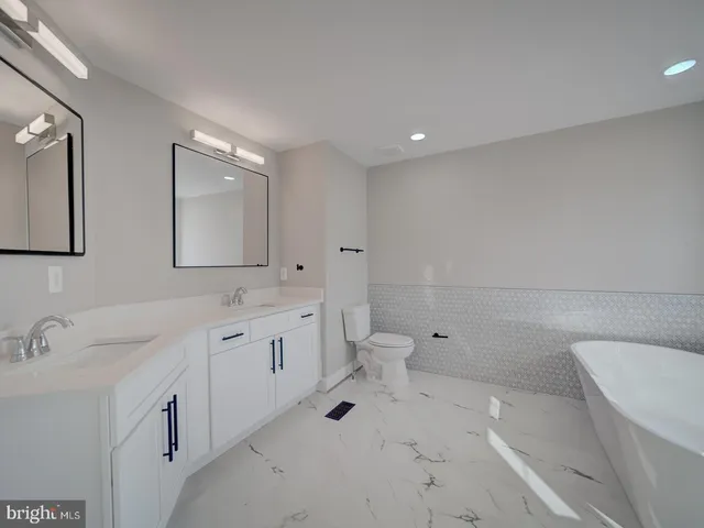 a view of kitchen with wooden floor and electronic appliances