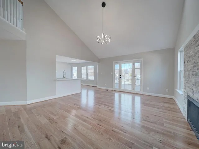 a view of an empty room and wooden floor
