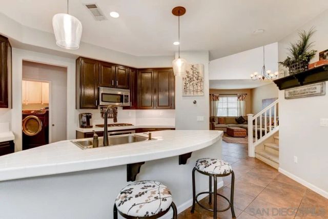 a kitchen with a table chairs stove and microwave