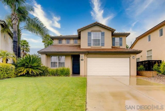 a view of a house with a yard and palm trees