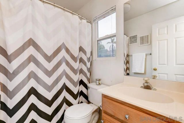a bathroom with a sink toilet and mirror