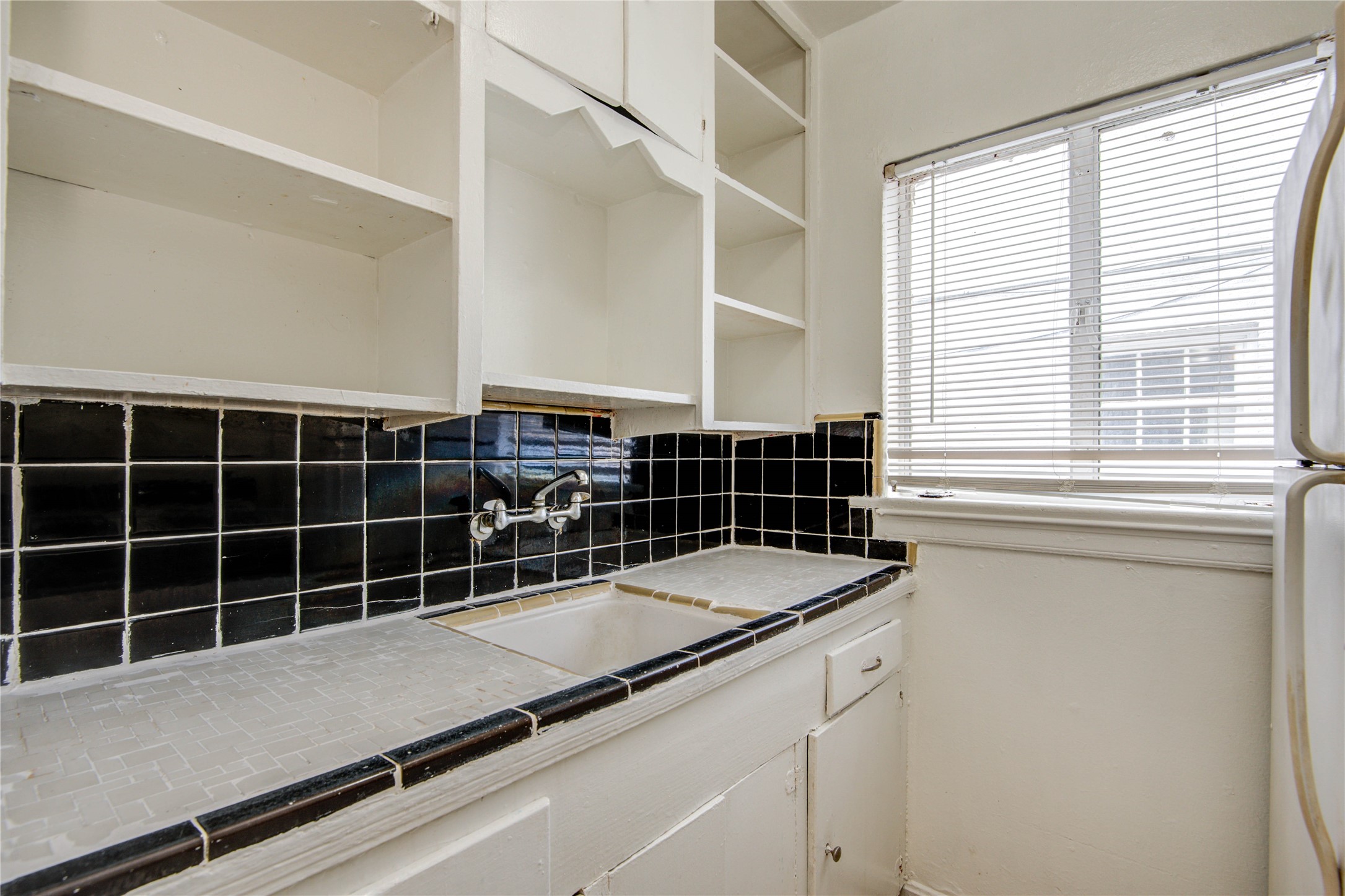 1828 West Main Street, Unit 1 Houston, TX 77098 - Photo 19 of 20 a view of a kitchen with granite countertop a sink and a large window