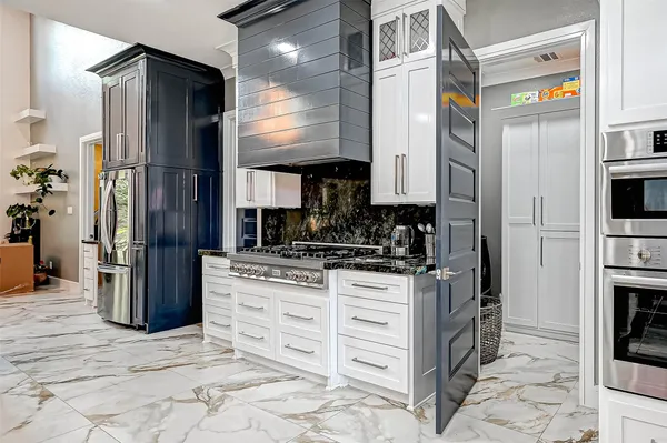 a kitchen with stainless steel appliances granite countertop a refrigerator and a stove