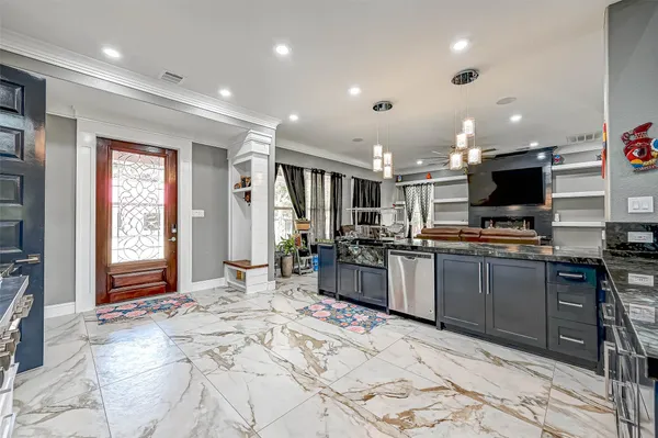 a large kitchen with stainless steel appliances kitchen island granite countertop a sink and cabinets