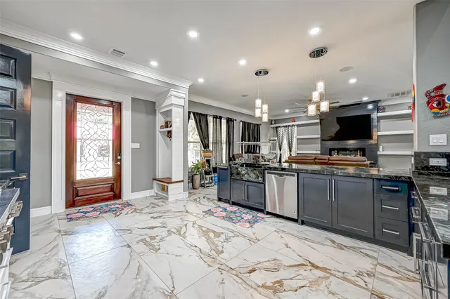 a large kitchen with stainless steel appliances kitchen island granite countertop a sink and cabinets