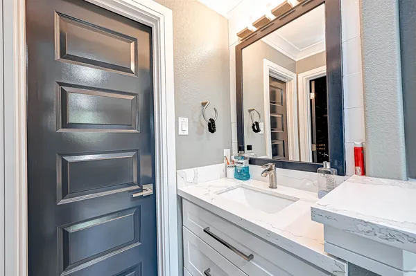 a bathroom with a sink and a mirror