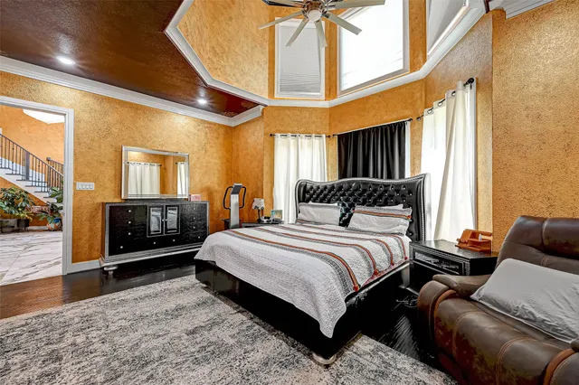 a bedroom with a bed a couch and dresser