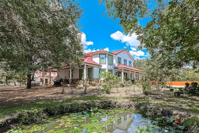 a front view of a houses with yard and green space