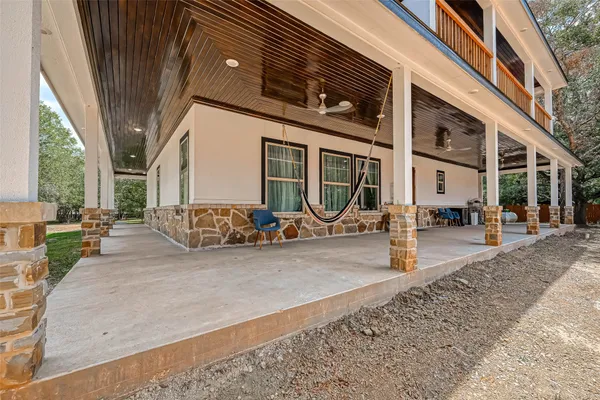 a view of a house with backyard porch and sitting area