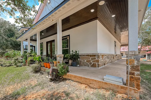 a view of a house with backyard porch and sitting area