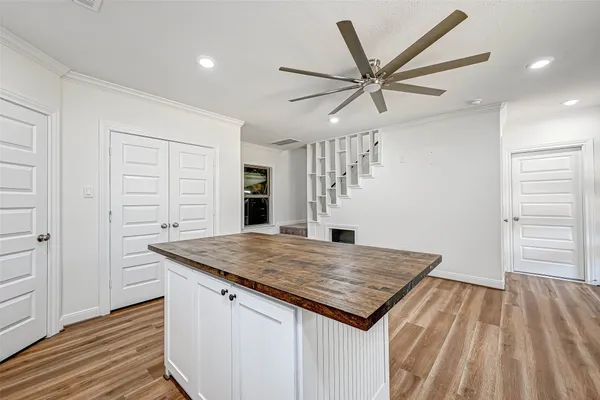 a kitchen view with granite countertop a stove and a wooden floor