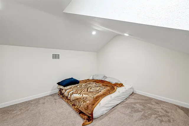 a bedroom with a bed and a night stand