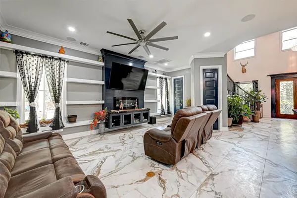 a living room with furniture a window and a flat screen tv