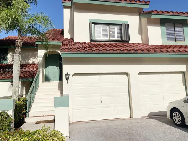 a front view of a house with parking