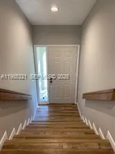 a view of a room with wooden floor