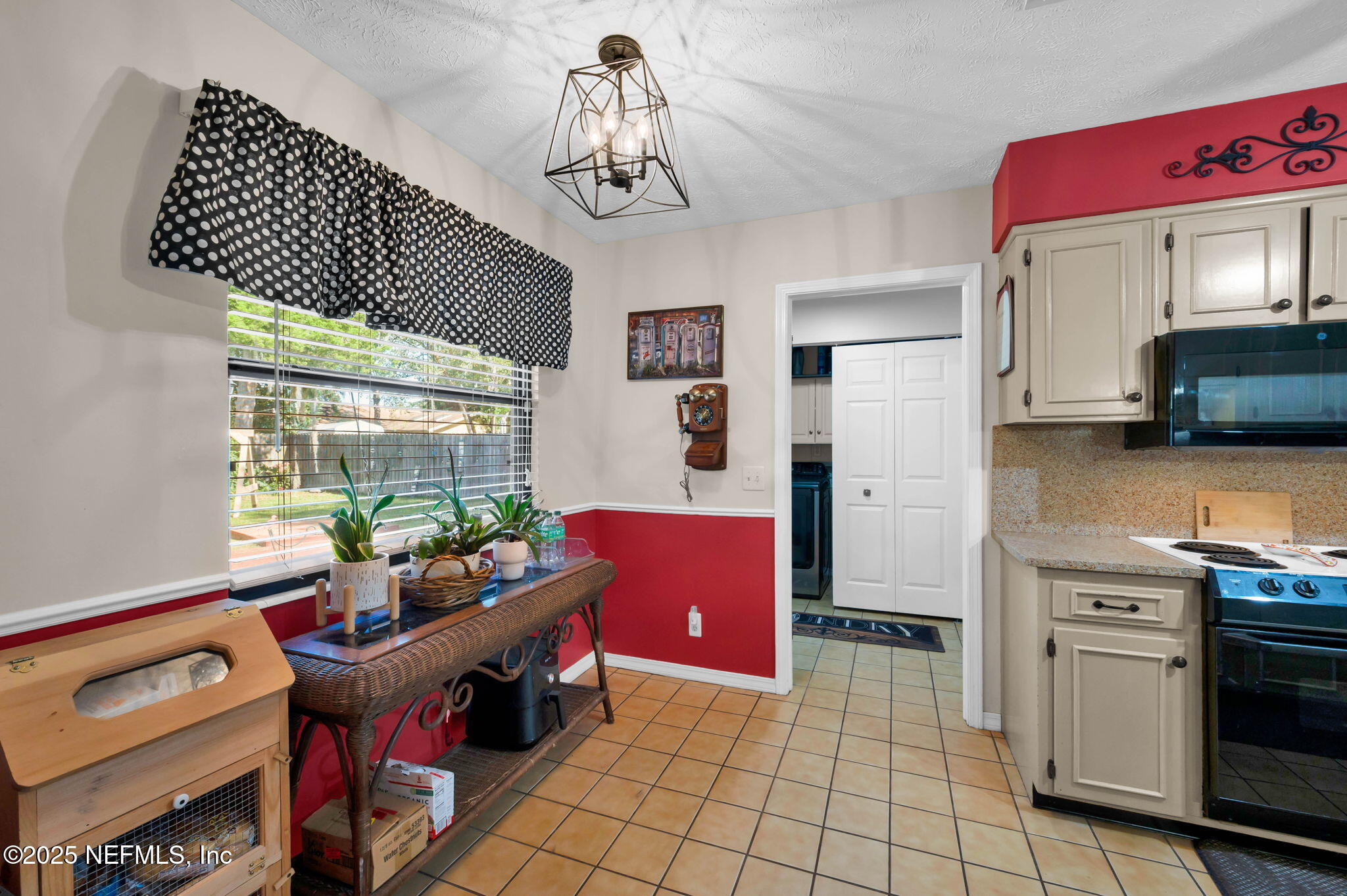5495 Forrest Drive Orange Park, FL 32073 - Photo 12 of 34 a kitchen with stainless steel appliances granite countertop a stove a sink dishwasher and a microwave with wooden floor