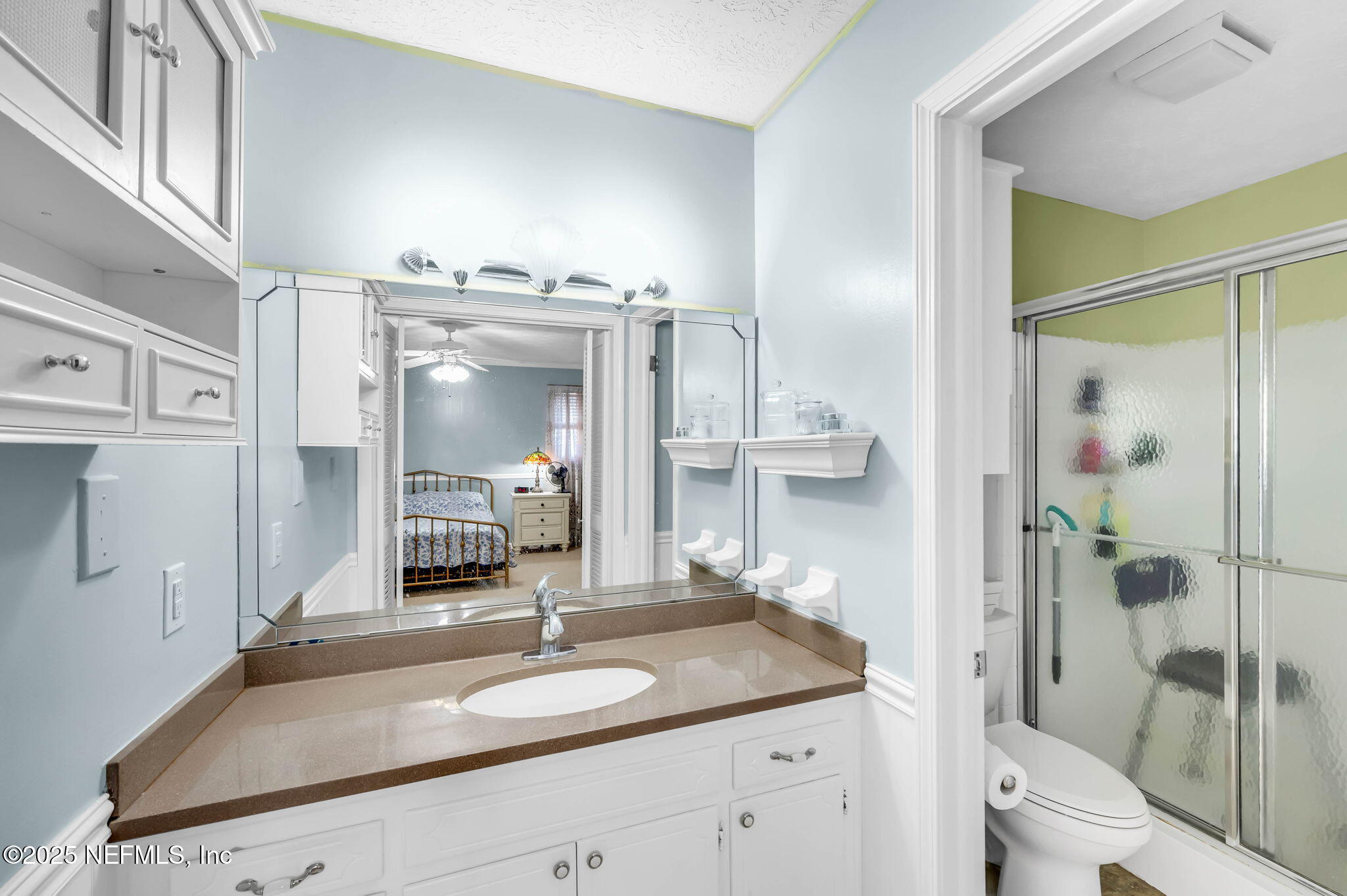 5495 Forrest Drive Orange Park, FL 32073 - Photo 21 of 34 a en suite bathroom with a granite countertop sink and a mirror