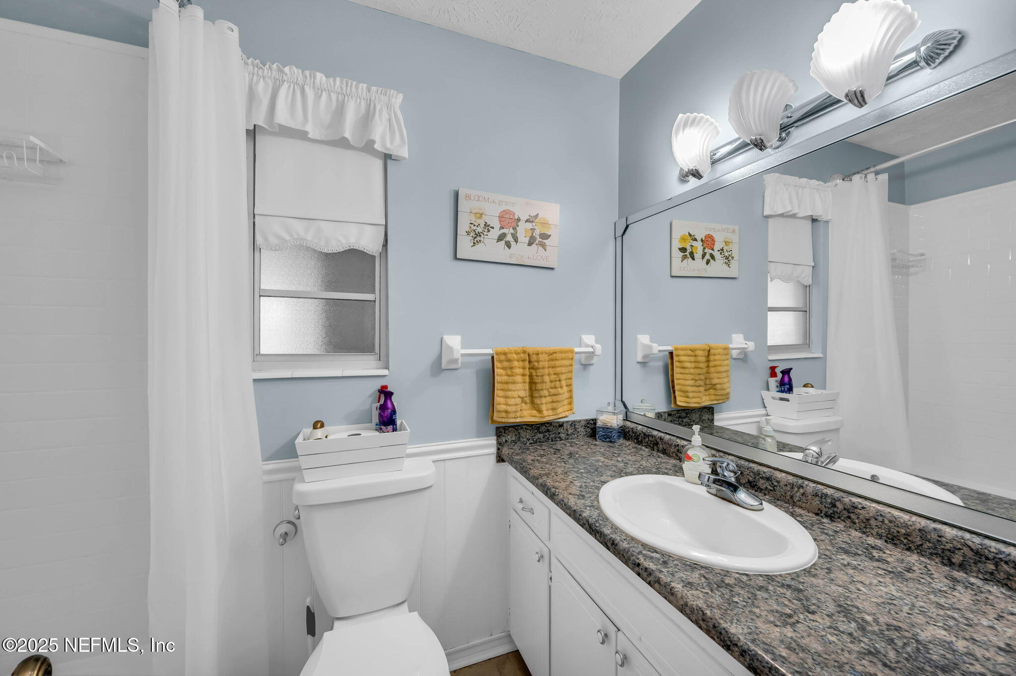 5495 Forrest Drive Orange Park, FL 32073 - Photo 26 of 34 a bathroom with a granite countertop sink mirror vanity and toilet
