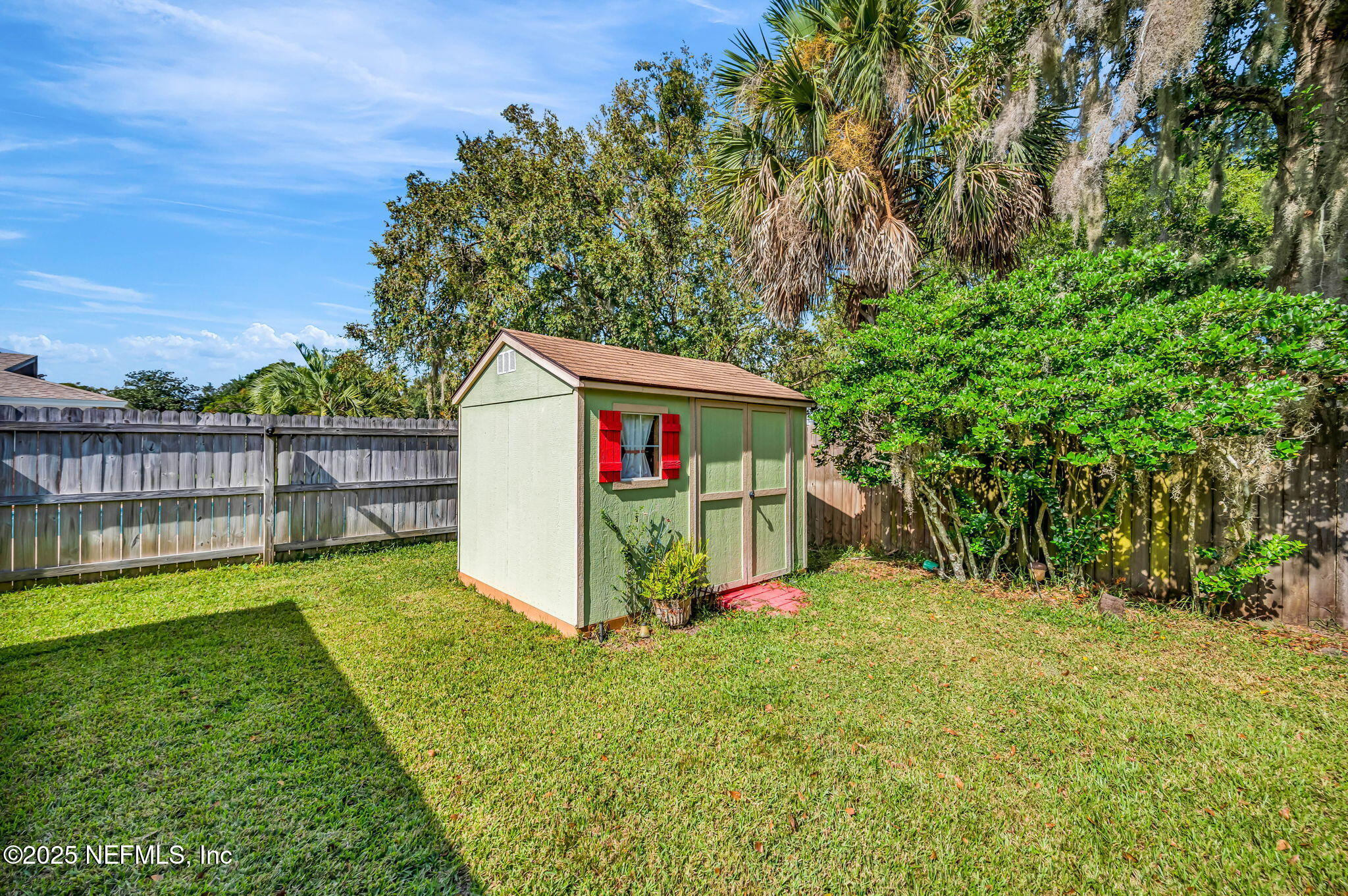 5495 Forrest Drive Orange Park, FL 32073 - Photo 31 of 34 a view of a backyard with a garden and deck