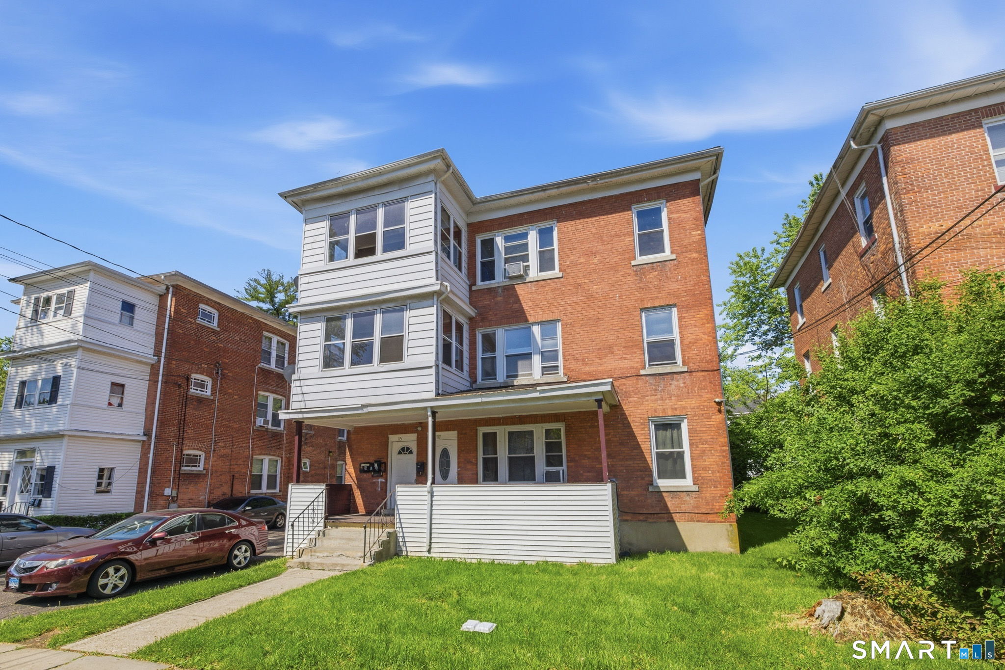 115 Baltimore Street, Unit 2 Hartford, CT 06112 - Photo 1 of 14 a front view of a house with a yard