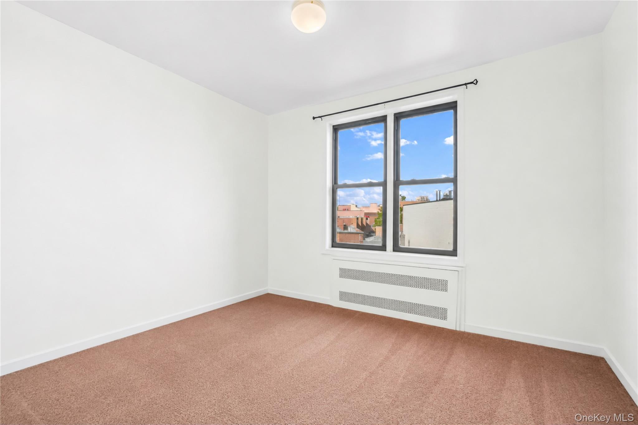 58-03 Calloway Street, Unit 5A Queens, NY 11368 - Photo 12 of 19 an empty room with windows