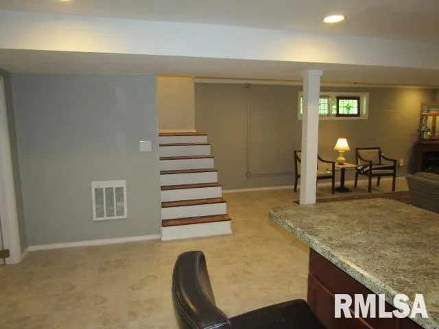 a view of a livingroom with furniture and staircase