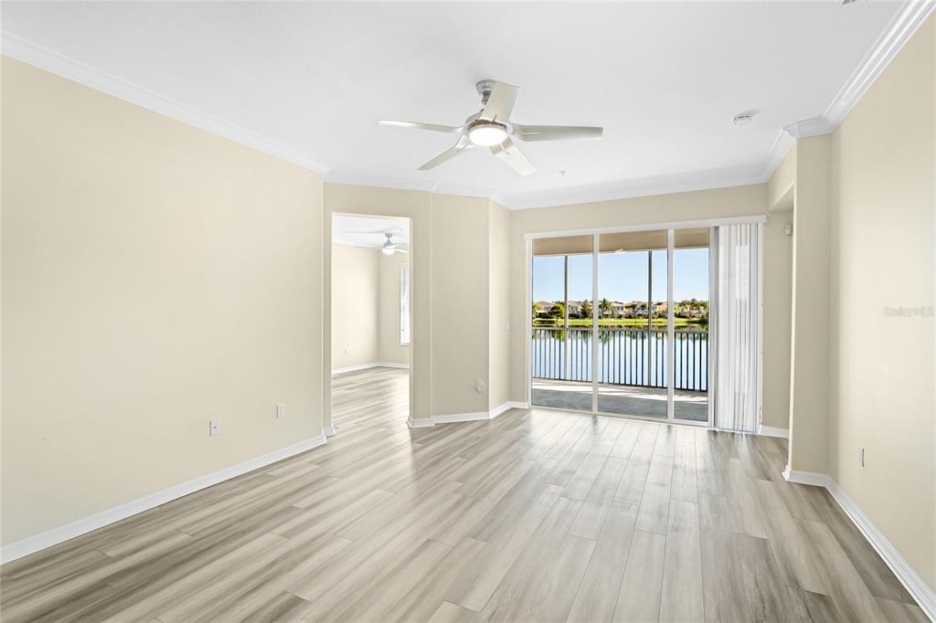 5677 Fossano Drive, Unit 506 Sarasota, FL 34238 - Photo 16 of 44 wooden floor in an empty room with a window