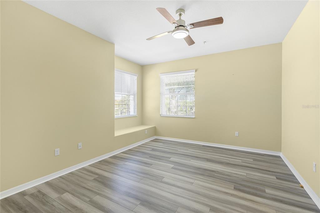 5677 Fossano Drive, Unit 506 Sarasota, FL 34238 - Photo 21 of 44 wooden floor in an empty room with a window