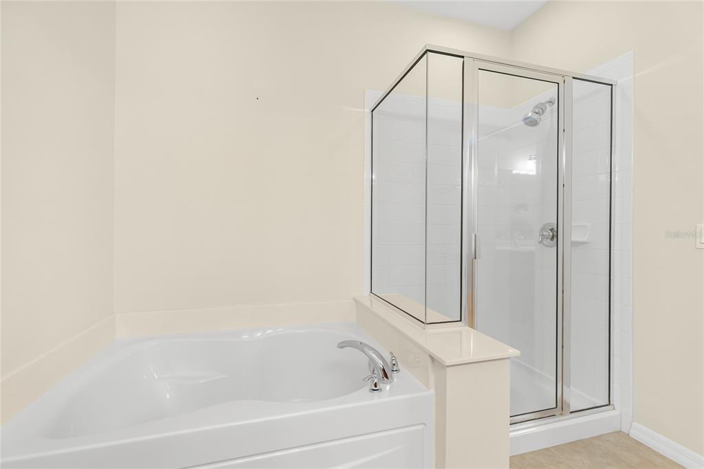 5677 Fossano Drive, Unit 506 Sarasota, FL 34238 - Photo 22 of 44 a bathroom with a bathtub and a shower