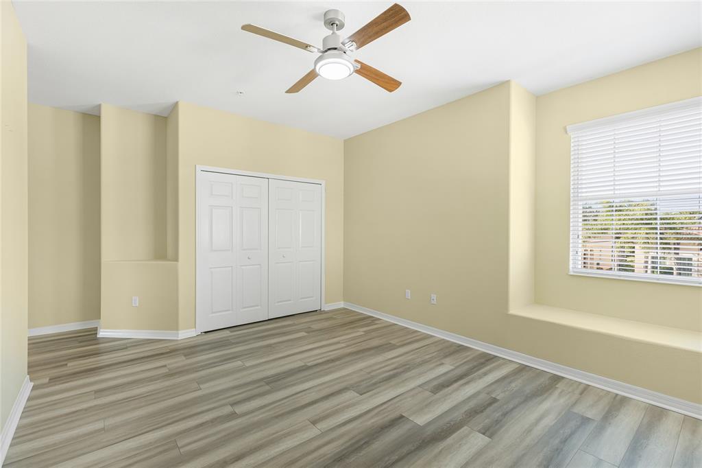 5677 Fossano Drive, Unit 506 Sarasota, FL 34238 - Photo 23 of 44 a view of empty room with wooden floor and fan