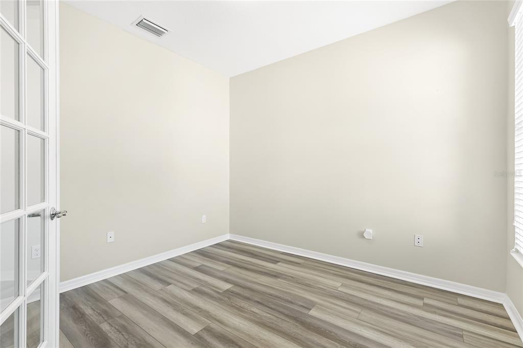 5677 Fossano Drive, Unit 506 Sarasota, FL 34238 - Photo 25 of 44 a view of a room with wooden floor