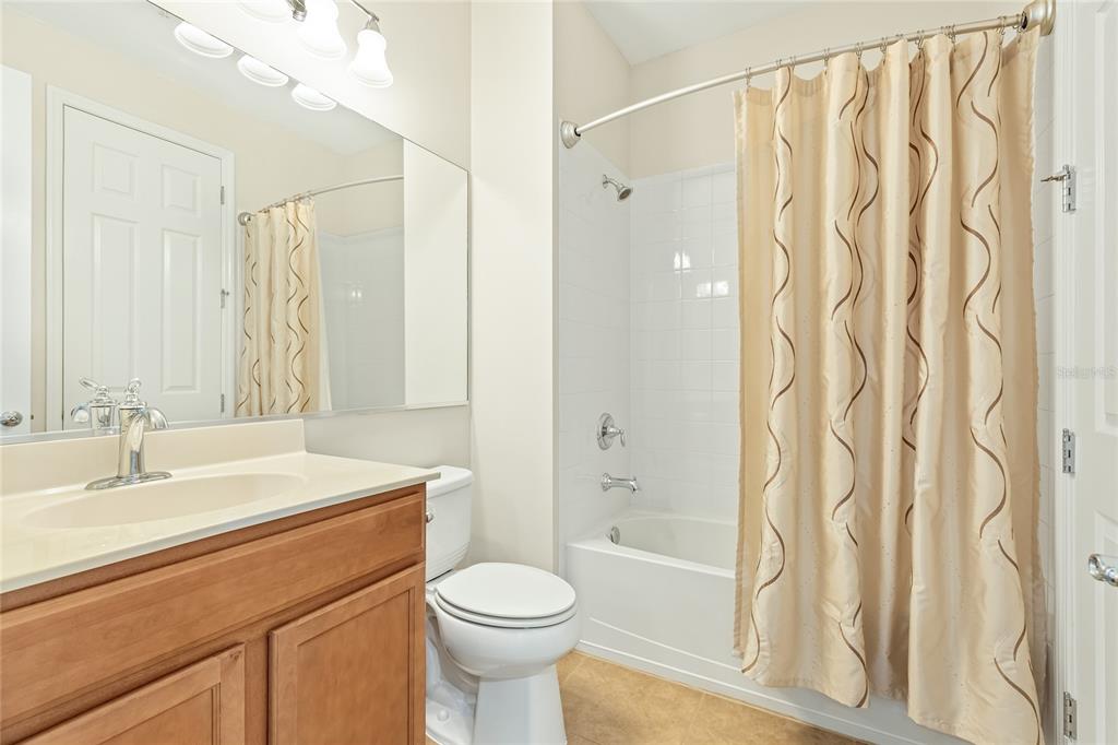 5677 Fossano Drive, Unit 506 Sarasota, FL 34238 - Photo 26 of 44 a bathroom with a sink a toilet and shower