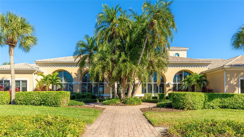 5677 Fossano Drive, Unit 506 Sarasota, FL 34238 - Photo 30 of 44 a front view of a house with a garden