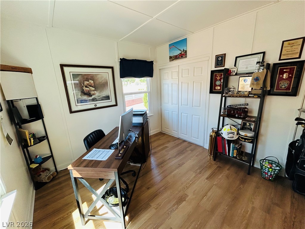 116 West Basic Road Henderson, NV 89015 - Photo 15 of 39 A quiet office space offers abundant natural light and versatile wooden flooring, ideal for productivity.
