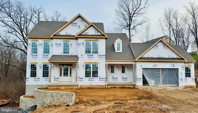 a front view of a house with swimming pool and furniture