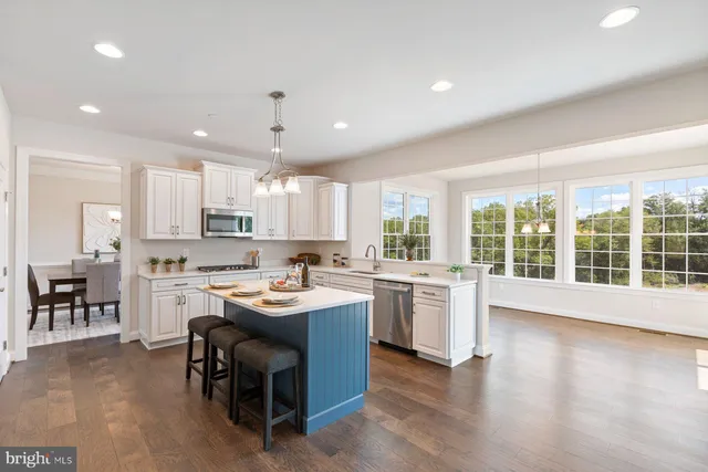 a view of a living room and kitchen floor to ceiling window