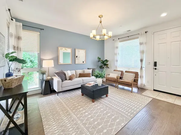 a living room with furniture and a chandelier