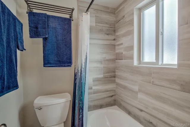 a bathroom with a toilet and a shower