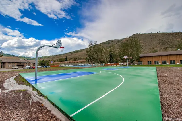 a view of a playground with basketball court