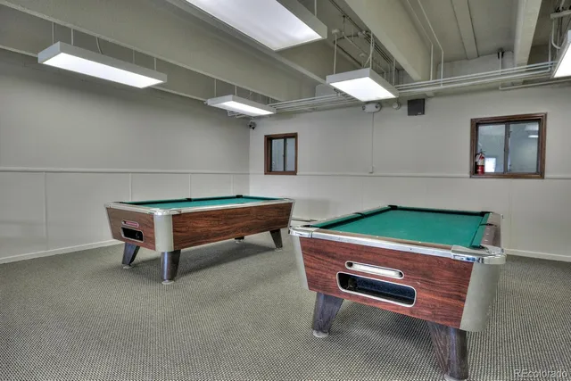 a area with wooden furniture and a ceiling fan