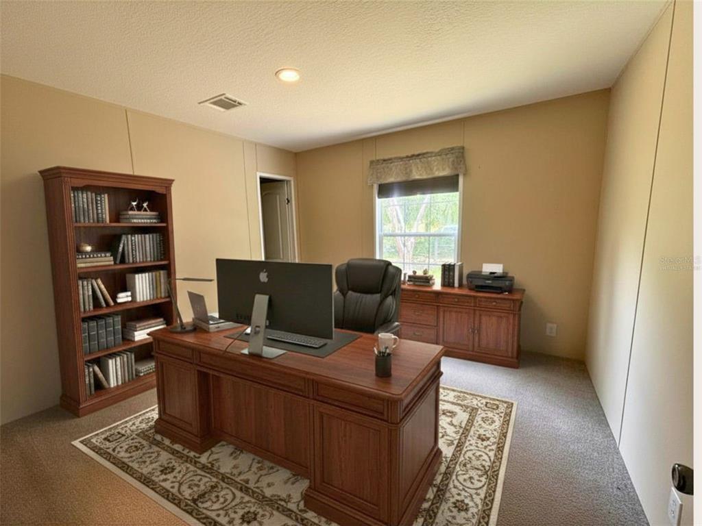 9827 Southeast Hoth Road Arcadia, FL 34266 - Photo 23 of 28 a living room with furniture a rug and a window