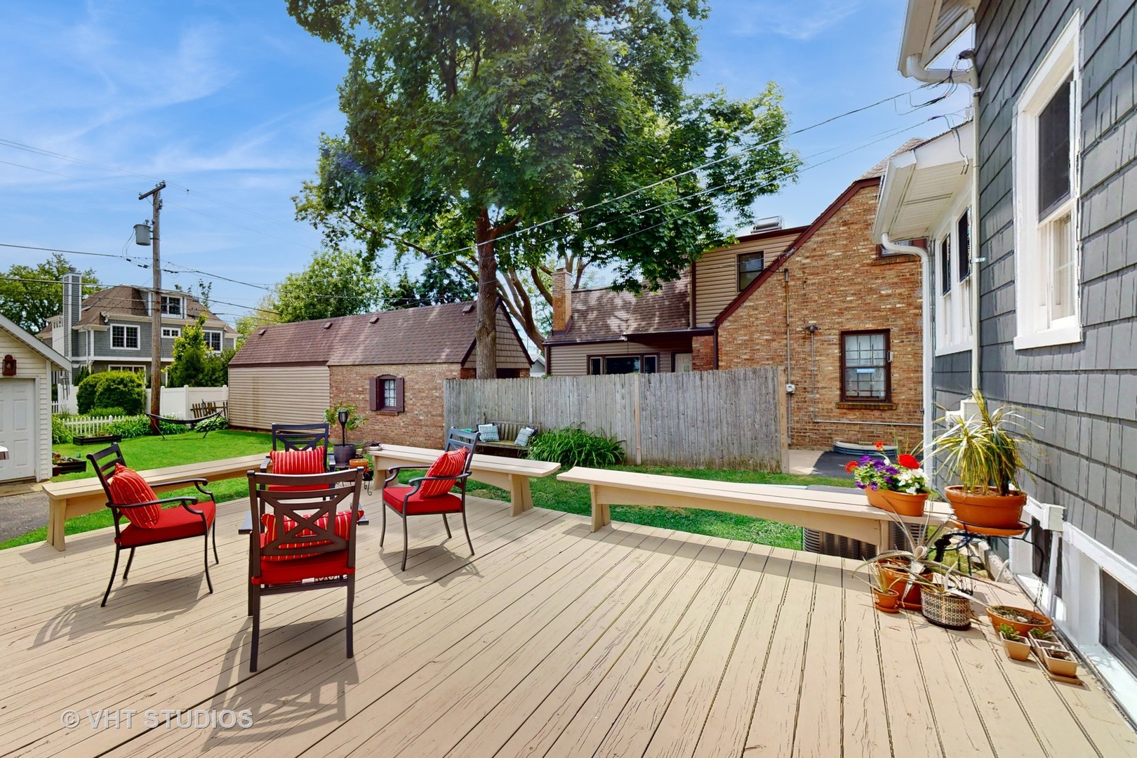 4627 Wolf Road Western Springs, IL 60558 - Photo 23 of 30 a backyard of a house with wooden floor outdoor seating and yard in the back