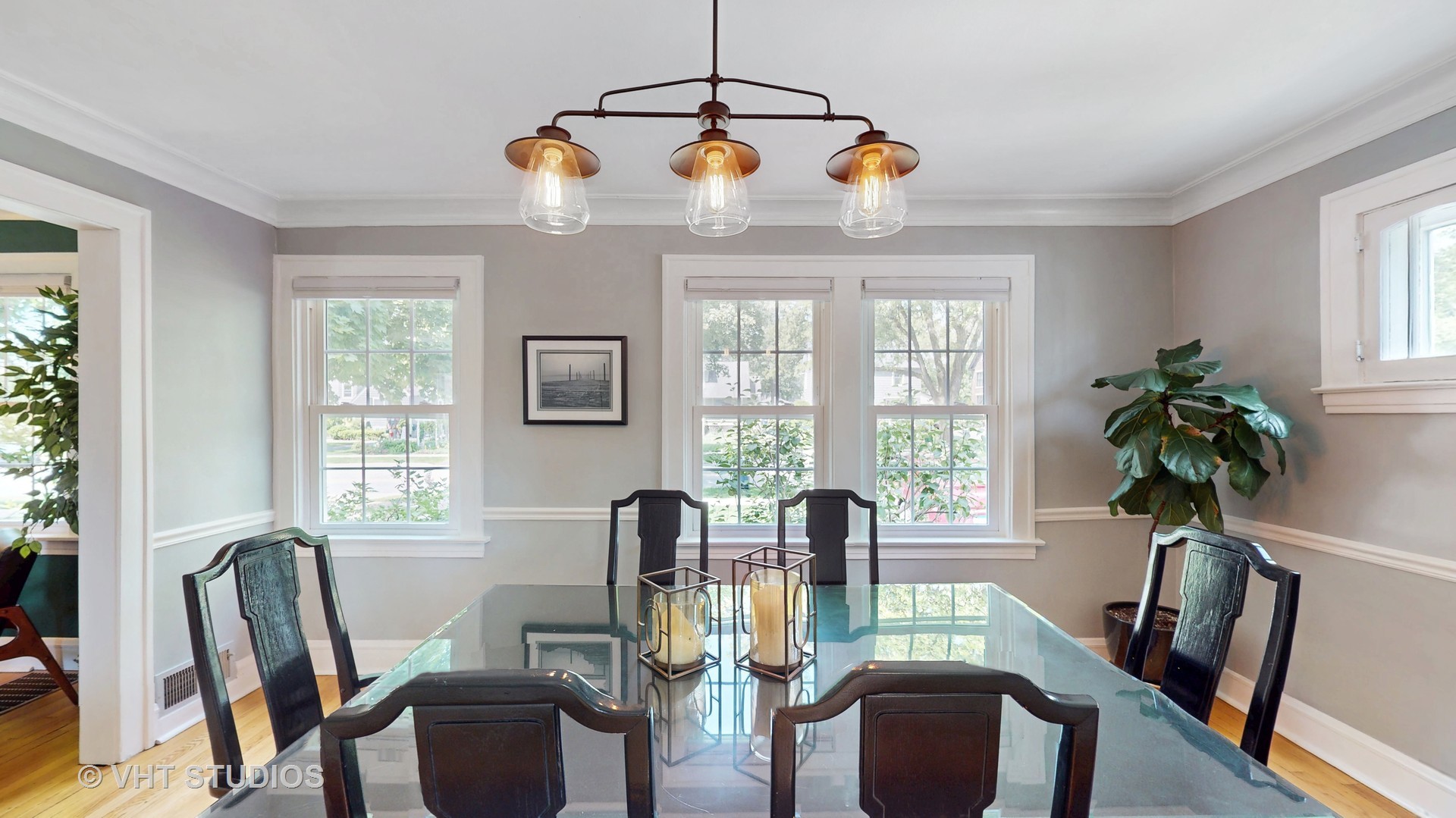4627 Wolf Road Western Springs, IL 60558 - Photo 7 of 30 a dining room with furniture potted plants and wooden floor