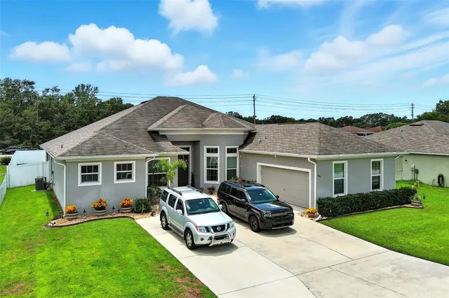 a car parked in front of a house with a yard