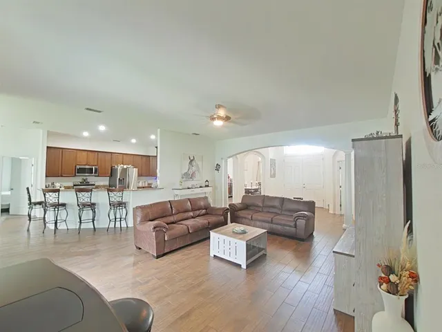 a kitchen with stainless steel appliances granite countertop a refrigerator stove microwave and sink