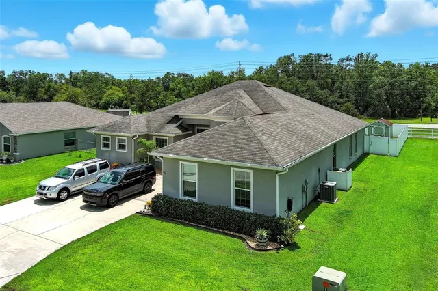 a aerial view of a house with a yard garden and patio