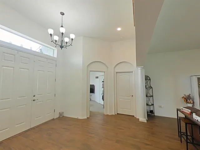 a living room with furniture a flat screen tv and a window